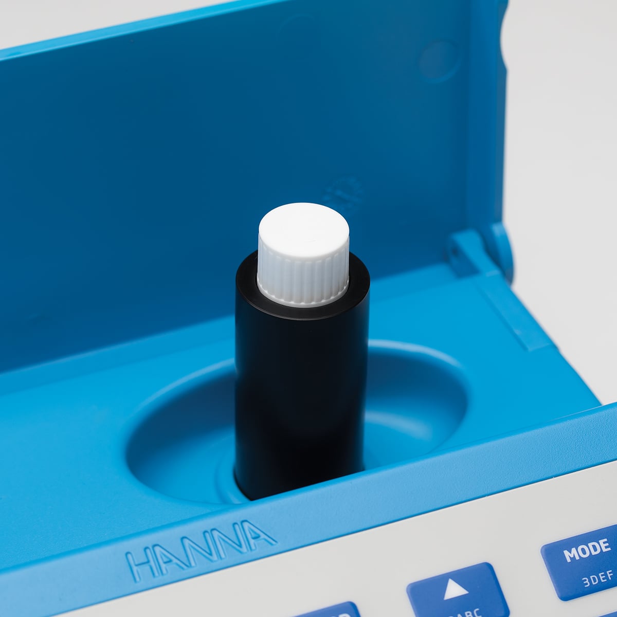 Close-up of the 16 mm vial adapter seated in the Hanna photometer cuvette holder